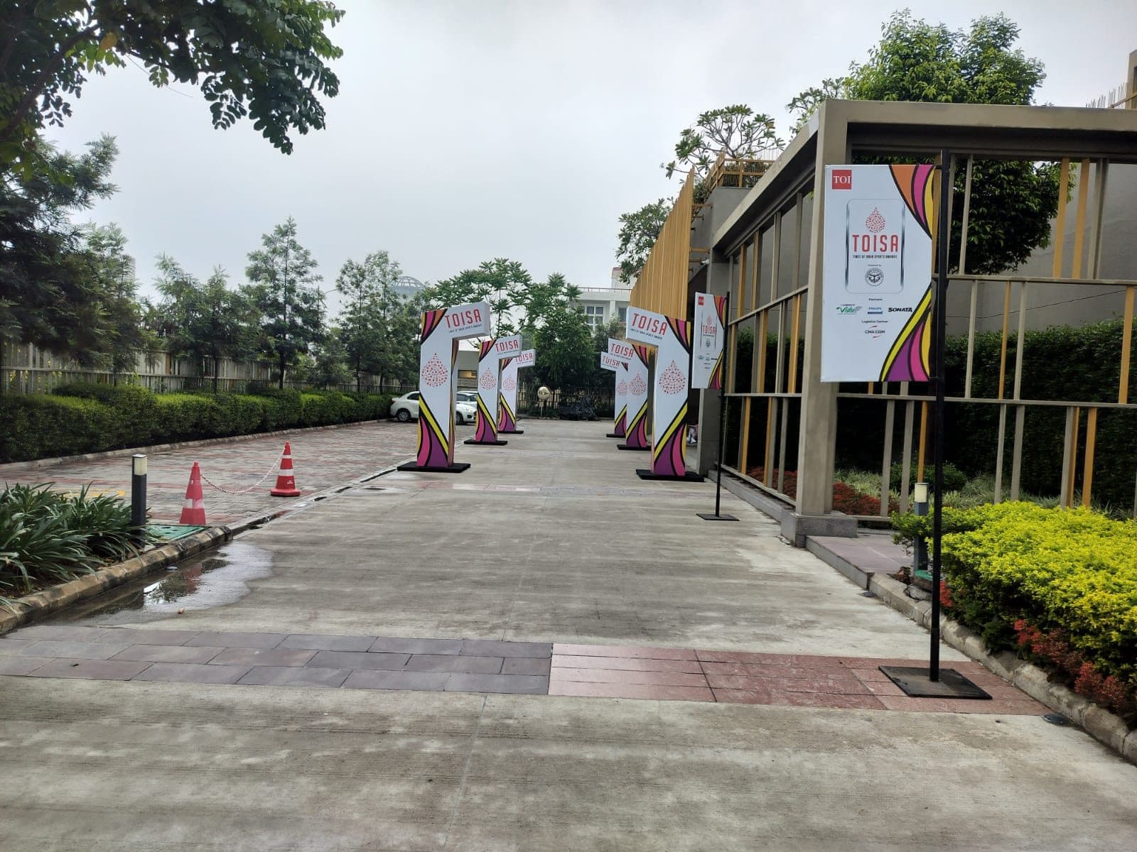 Outdoor walkway lined with TOISA branded archway signage