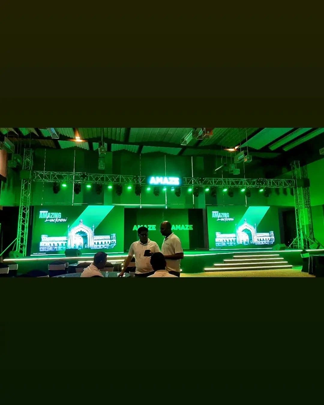 Lighting truss rig with moving-head fixtures over LED video wall