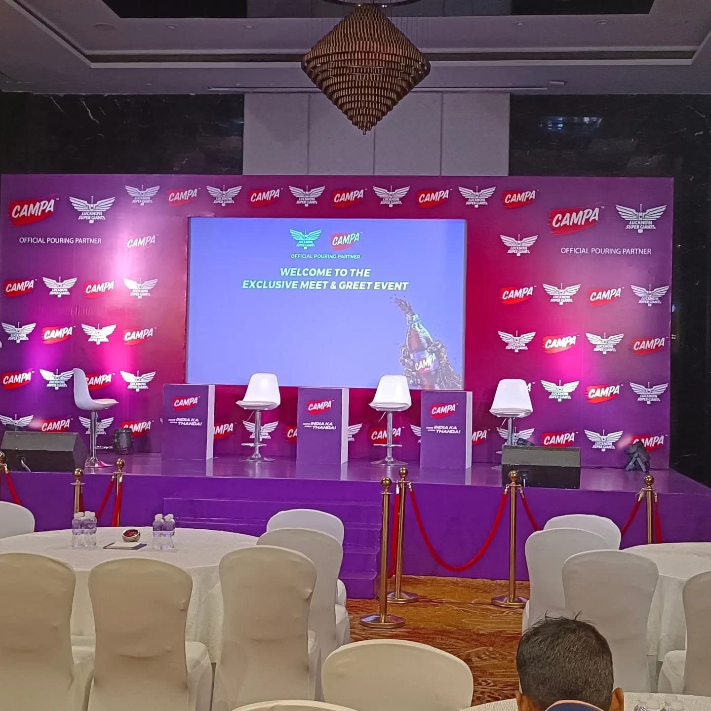Branded stage with large LED screen and mood lighting